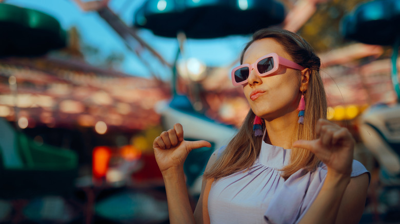 Woman posing and pointing at herself