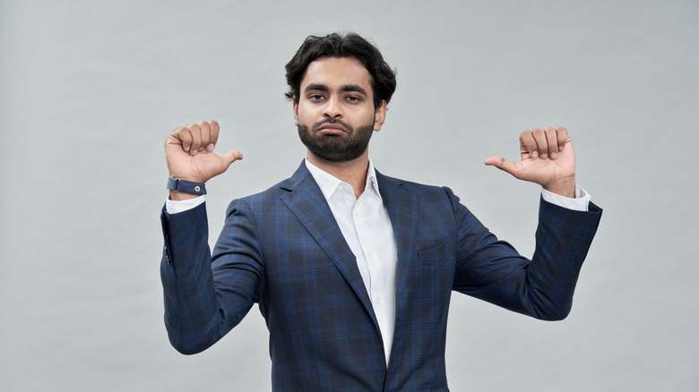 Confident man pointing at himself