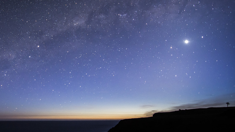 A long exposure photo of landscape at twilight with Venus in the sky