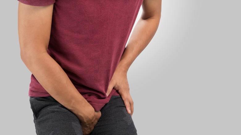 Man experiencing pain from urinary retention