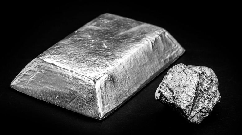 Platinum plate and ore on black background