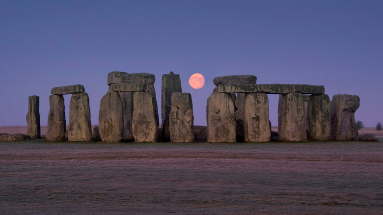 View of moon between Stonehenge megaliths