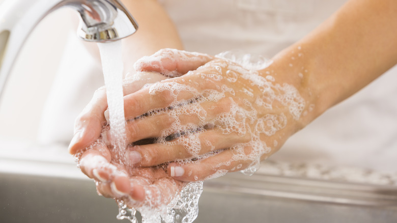 handwashing at faucet