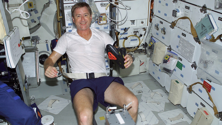 Astronaut exercising on a cycling machine on the ISS