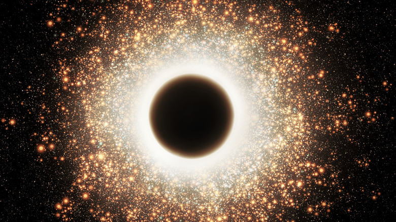 A black hole is visualized as an explosion of yellow light particles against a black background