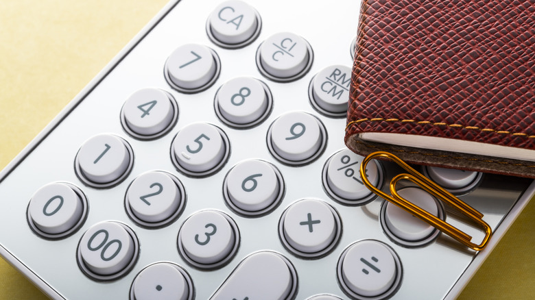 Calculator with notebook and paperclip