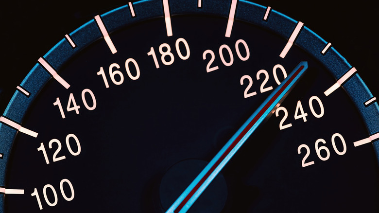 Close up of a speedometer reading about 230