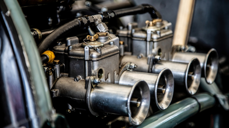 Close up of engine with shiny carburetors