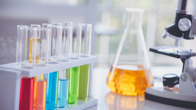 Beaker and test tubes with colored liquids in lab