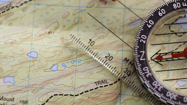 Close up of a topographical map with ruler and compass