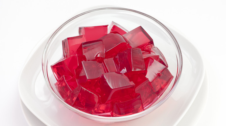 Cubes of red jello in a glass bowl