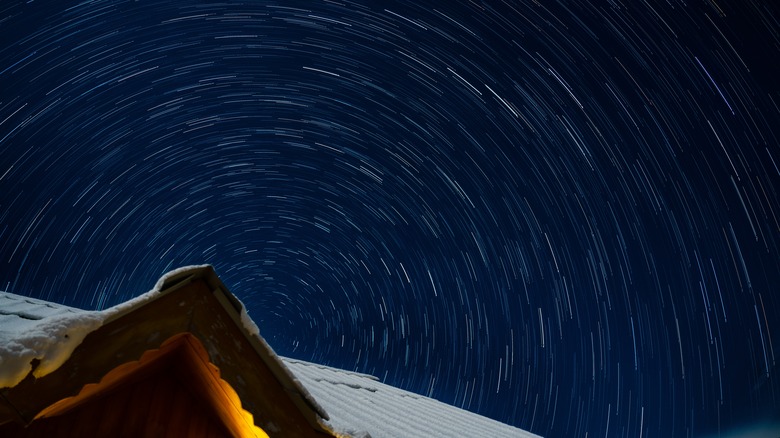 A long exposure photo of stars at night whose trails form a circular patter