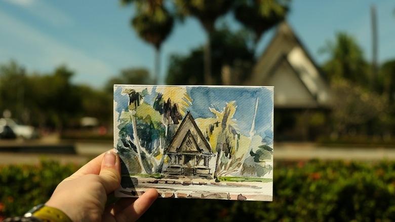 A blue, green, and yellow pastel painting of a house