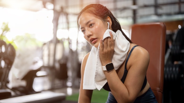 Woman drying sweat postworkout