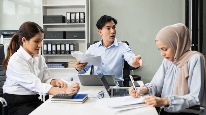 Man reacting angrily to workmate