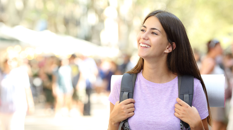 Woman on her own smiling happily