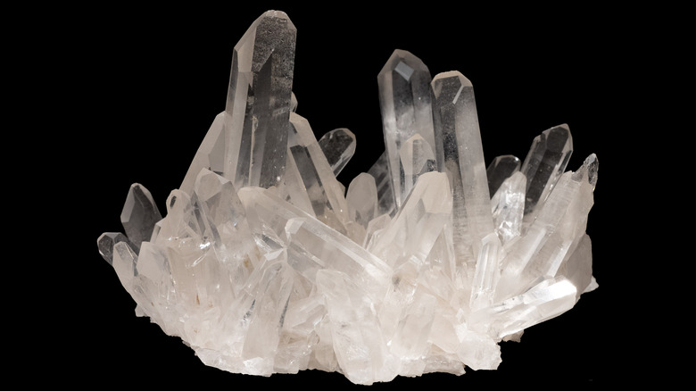 Cluster of quartz crystals on black background