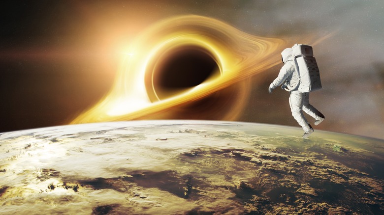 Rendering of Spaceman looks at black hole on low-orbit of Earth planet