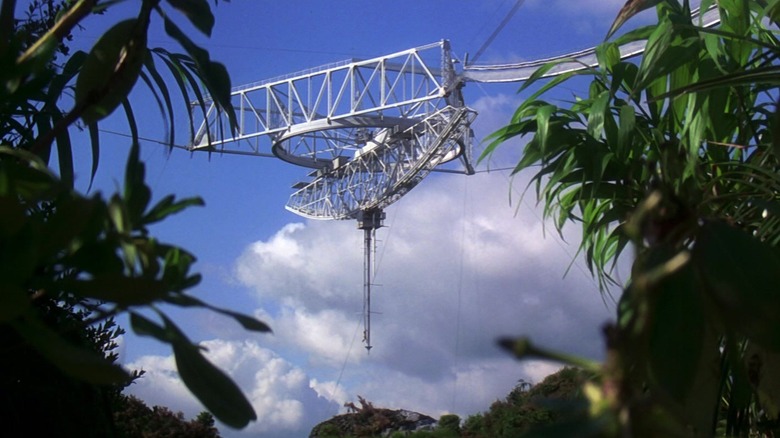 The Arecibo Observatory receiver platform is shown through trees in GoldenEye