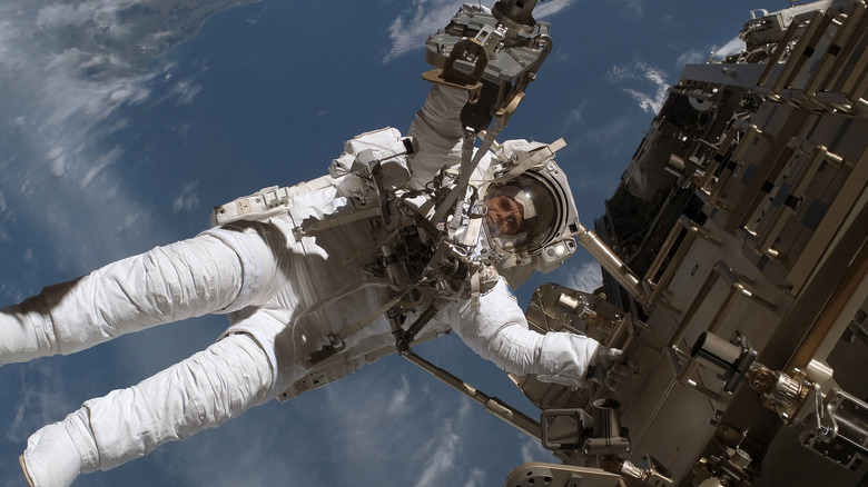 An astronaut wearing a spacewalk suit on the outside of the ISS