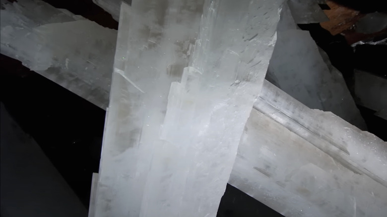 Giant beams of Selenite crystals criss cross each otehr in the cave of the crystals in the BBC's How Earth Made Us