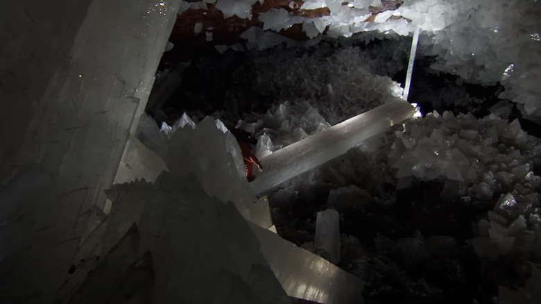 An individual walks along a giant Selenite crystal beam in the Cave of the Crystals as seen in the BBC's How Earth Made Us