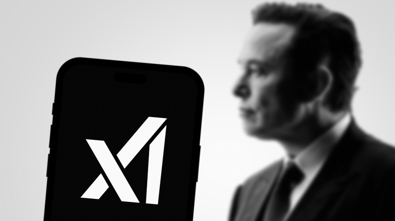 A phone showing the xAI logo appears in the foreground, with a blurry black and white Elon Musk in the background