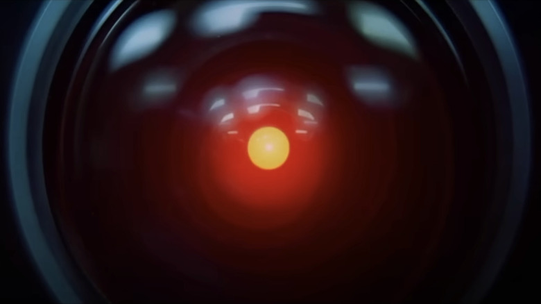 A closeup of a red dot at the center of a black capsule represents HAL 9000 in 2001: A Space Odyssey