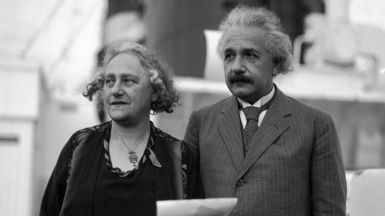 Einstein'sposing with his wife Elsa while holding papers