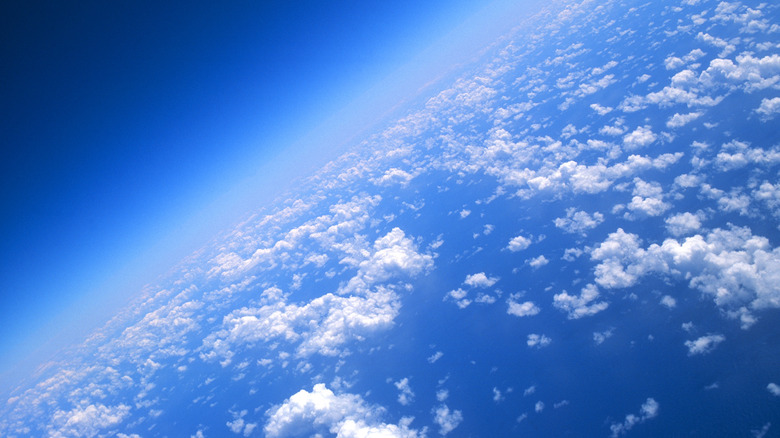 A picture of clouds in the upper atmosphere with the horizon in the distance