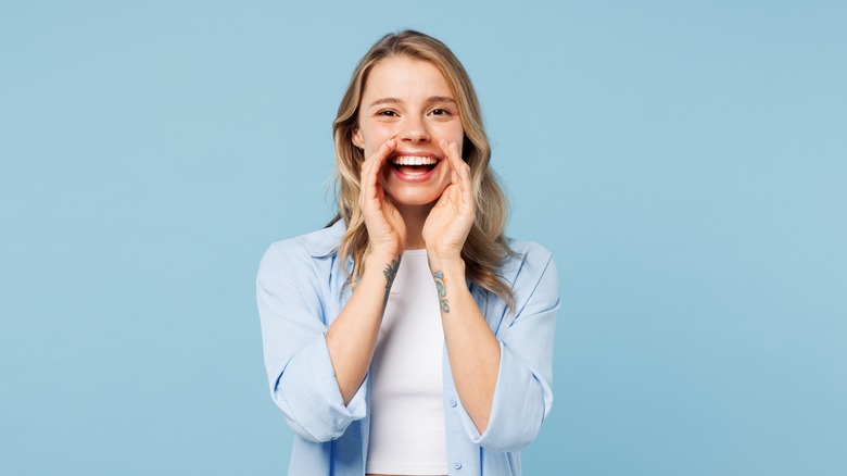 Woman cupping mouth