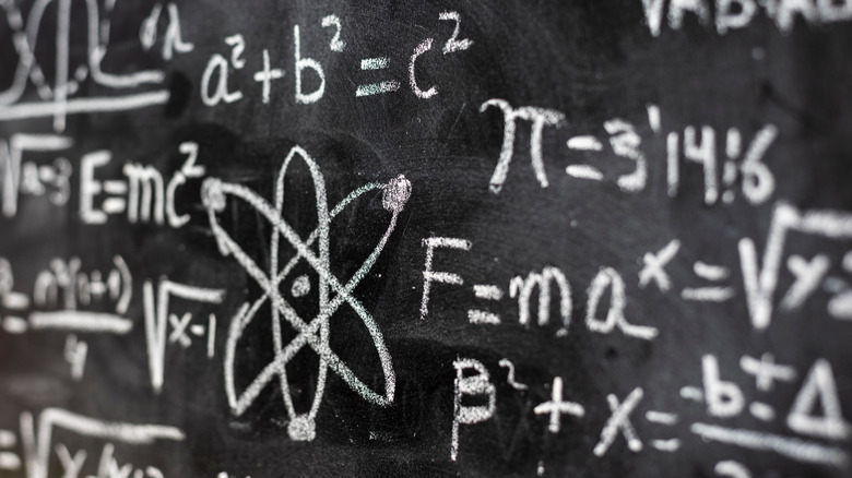 Quantum equations are shown drawn in chalk on a blackboard