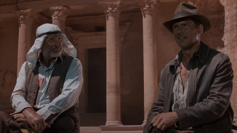 Indiana Jones and his father sit atop horses outside Al-Khazneh