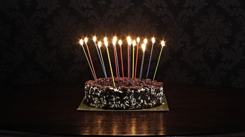 Chocolate birthday cake with tall candles