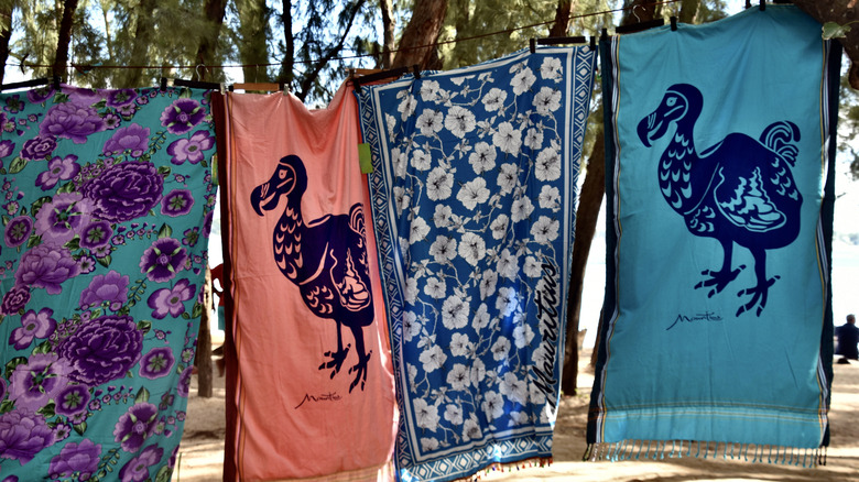 Towels depicting the dodo bird hang from a laundry line