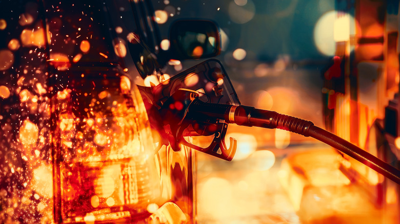 Gas pump nozzle in car with an overlay of flames and embers