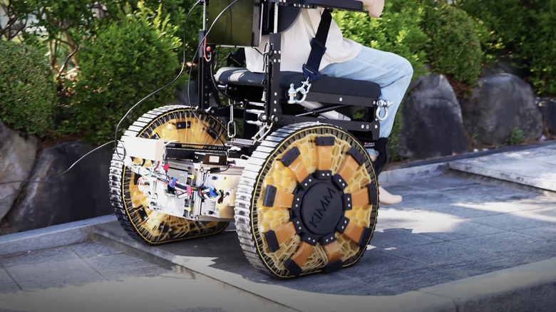 A morphing wheel design is shown adapting to flat terrain on a prototype wheelchair