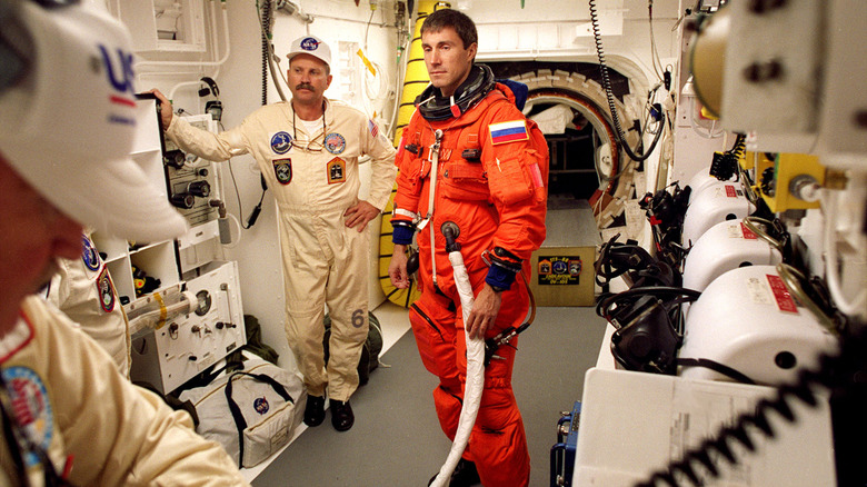 Sergei Krikalev in space suit entering Endeavor Space Shuttle