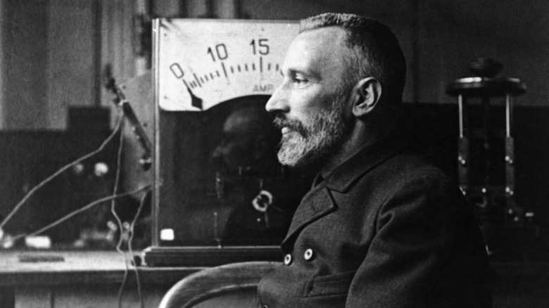 Pierre Curie sitting in front of equipment