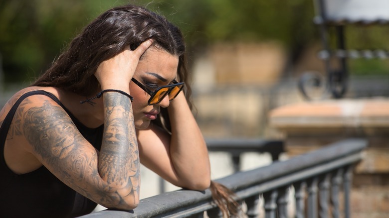 Anxious woman with hands on her head