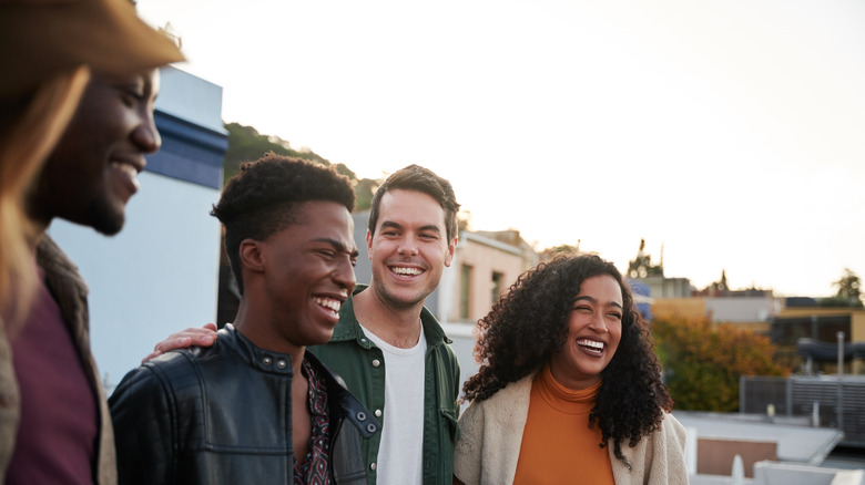 Group of four friends laughing