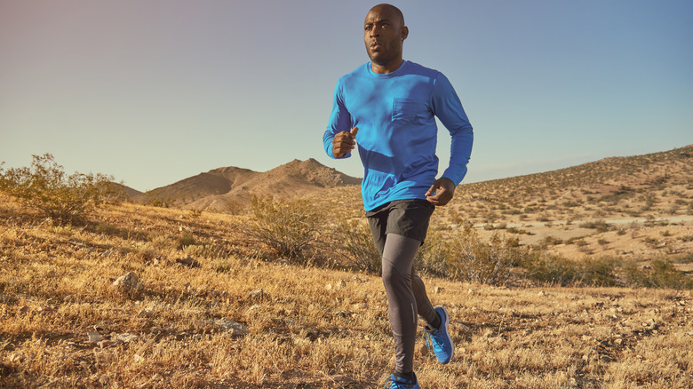 Man running outdoors on a trail