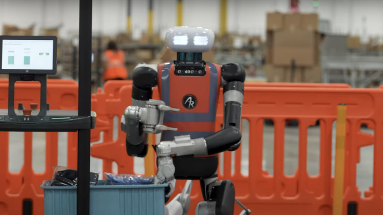 Agility Robotics' Digit robot holds a crate while working in a factory