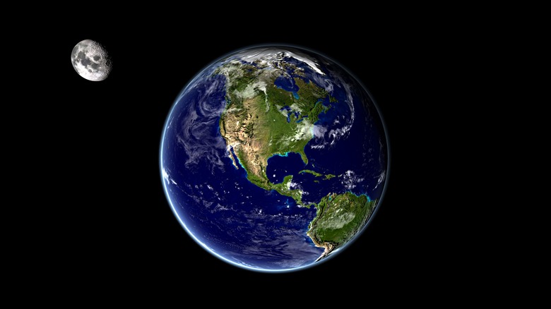 Depiction of Earth in space with Moon on its northwest side