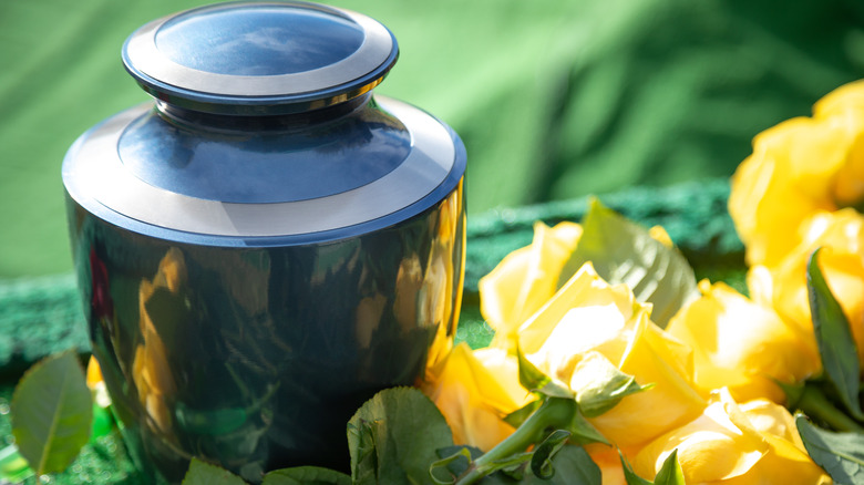 Urn with yellow flowers alongside