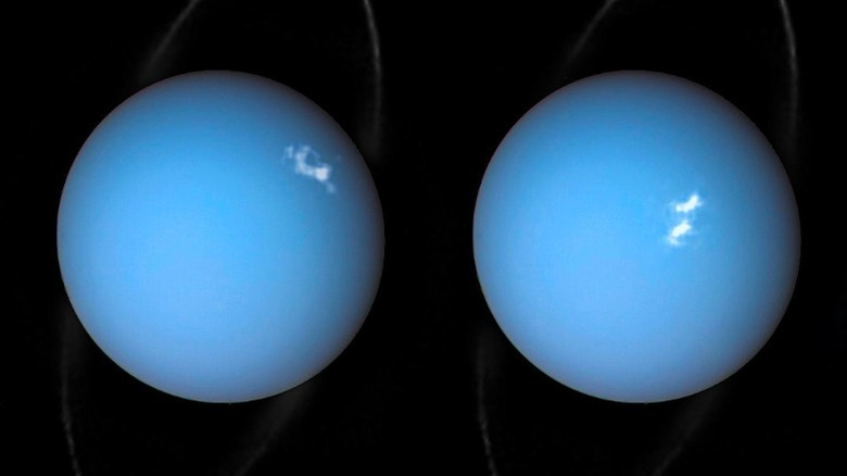 A pale blue sphere with a faint white ring and wisps of light against the black backdrop of space