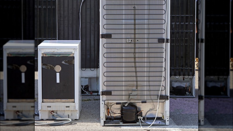 Backs of refrigerators showing compressors, condenser coils, and wiring