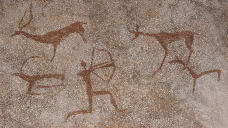 Prehistoric rock drawings of a hunter