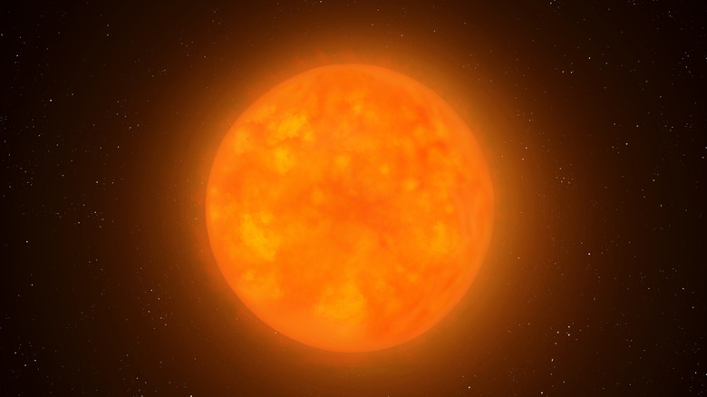 A dying orange star suspended in space