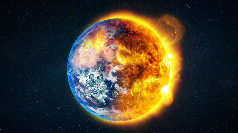 Planet Earth suspended in space with one side of the planet engulfed in flames